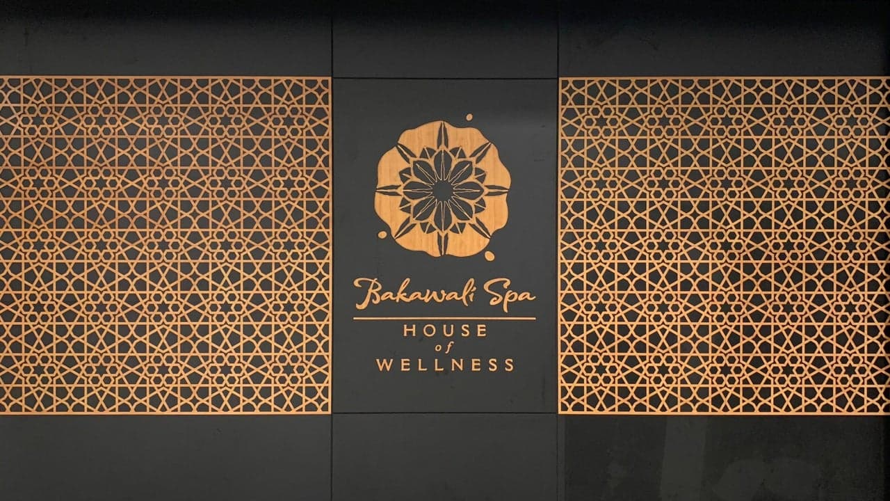 The copper Bakawali Spa logo and the words ‘House of Wellness’, between two carved geometric screens at the spa.